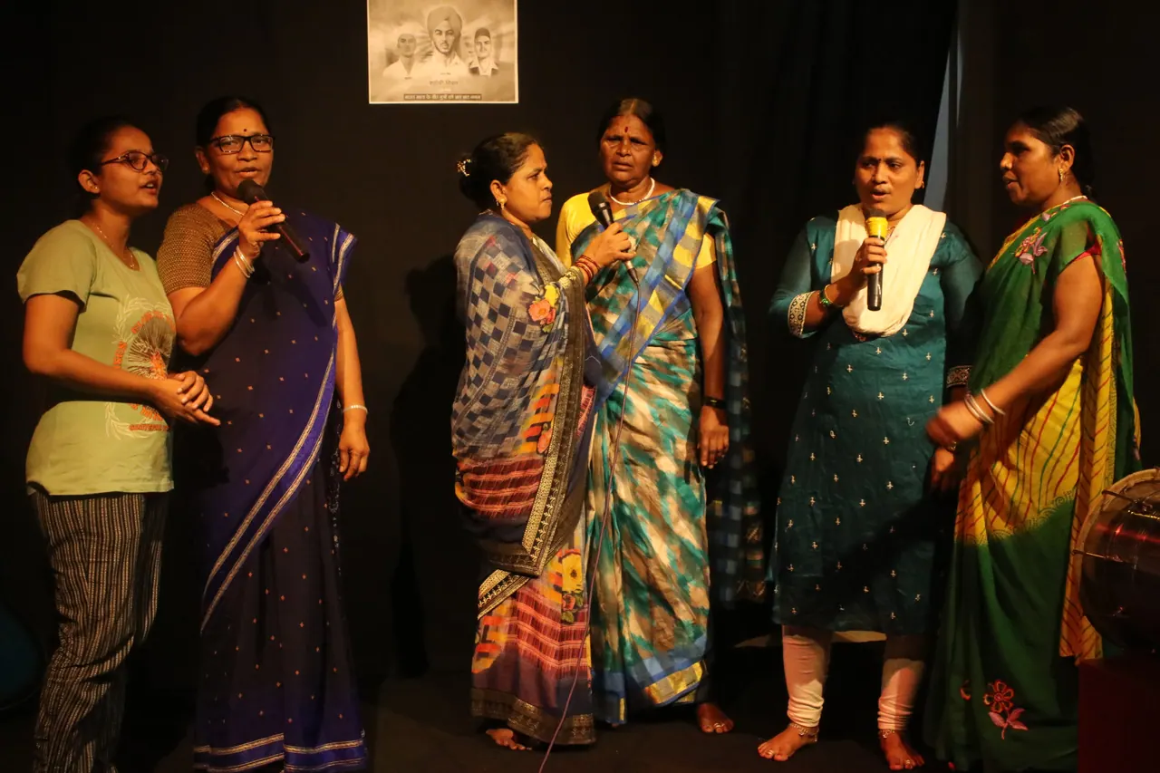 Women of Ramai Sanskrutik Manch singing together on stage.